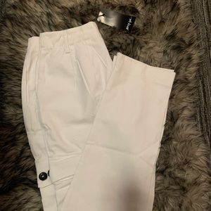 White cargo pants with pockets on side